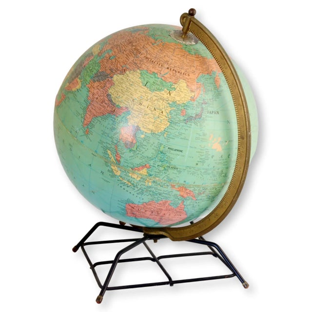 Experience a sense of wonder and adventure with this captivating Midcentury Desktop Globe. This unique piece of decor...