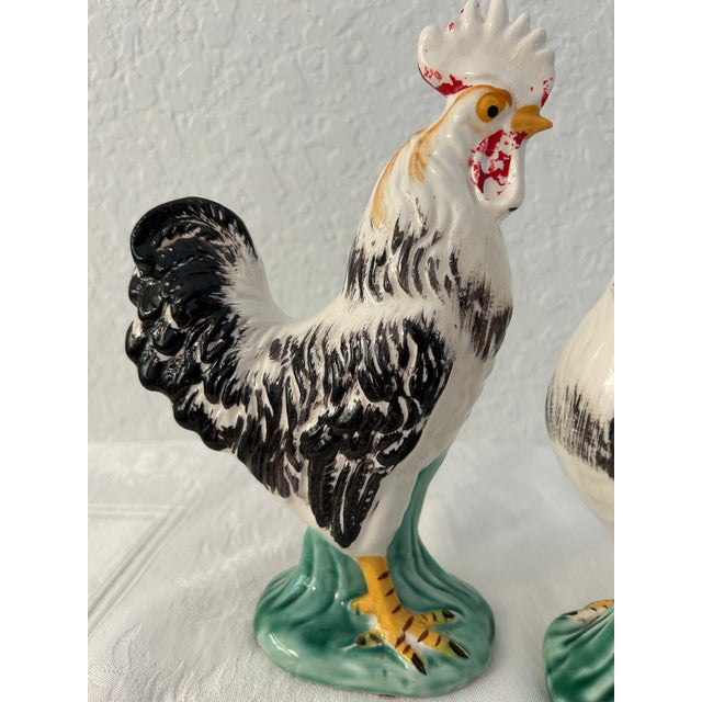 Charming pair of mid-century ceramic rooster figurines. Dimensions: large figurine, 9.25"H x 6"L x 3"W; small figurine,...