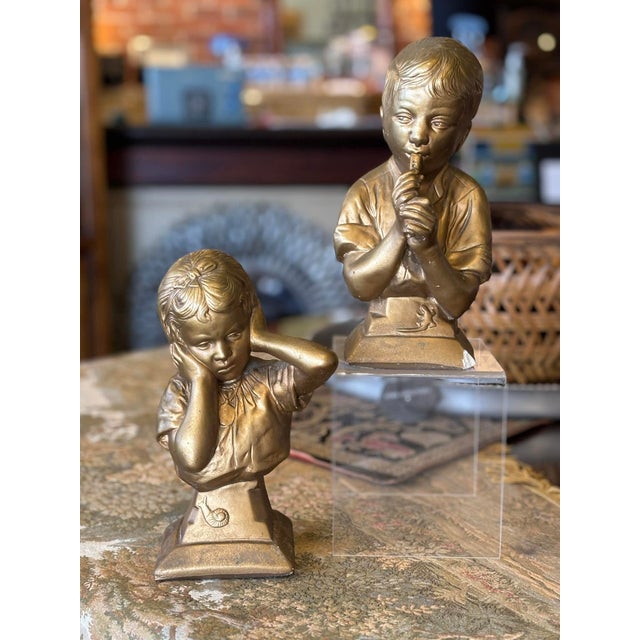 Sweet pair of chalkware bookends or busts finished in a muted gold. Each stamped with the Esco maker's mark. The boy...