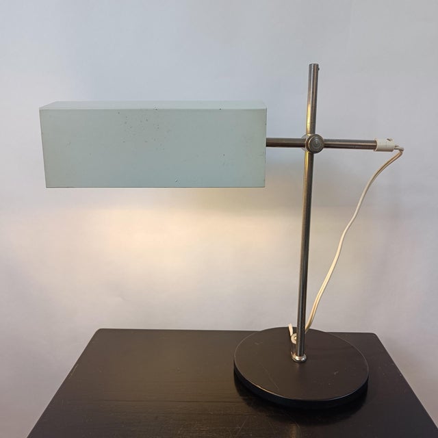 Minimalist table lamp by VEB Leuchtenbau Lengefeld from the 1960s. The lamp has a black lacquered metal base with a stand,...