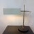 Minimalist table lamp by VEB Leuchtenbau Lengefeld from the 1960s. The lamp has a black lacquered metal base with a stand,...