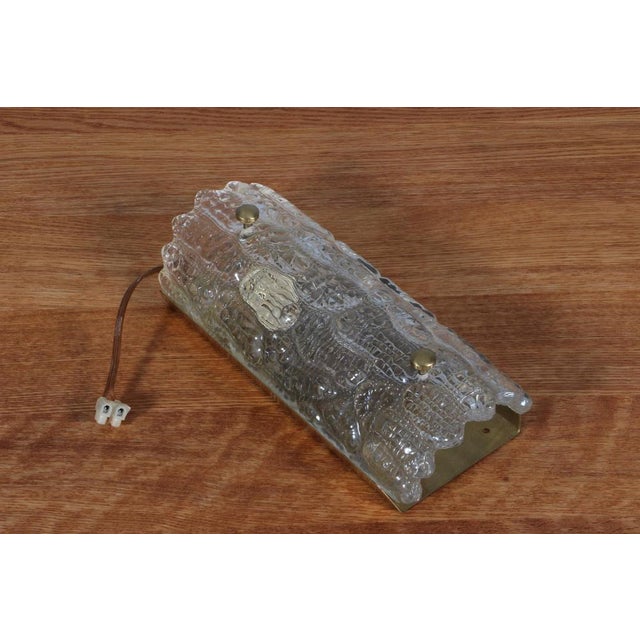 Carl Fagerlund wall lamp in glass and brass. Made by Lyfa/Orrefors. This piece is attributed to the mentioned...