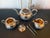 A four piece Chinese export silver tea service set consists of a lidded teapot, a creamer with lid, an open sugar and a...