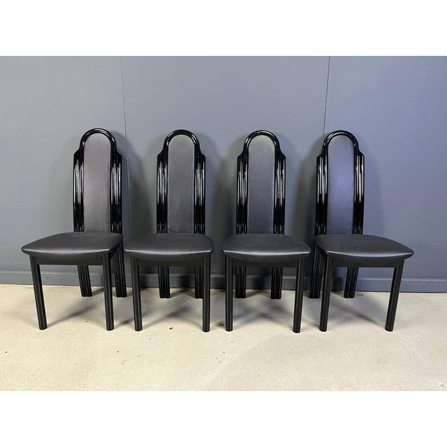Postmodern design dining chairs with black lacquered wooden frames and faux leather upholstery. 1980s - Italy Very good...