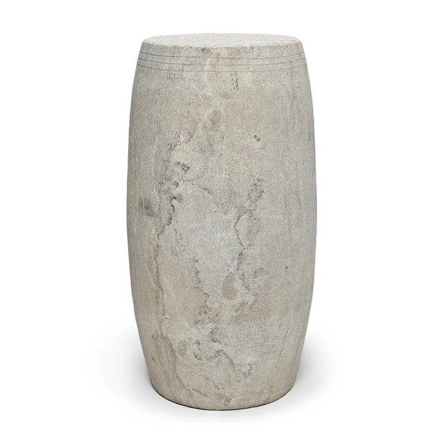This narrow drum stool was carved from a solid block of limestone with a Minimalist tapered design. The stool is subtly...