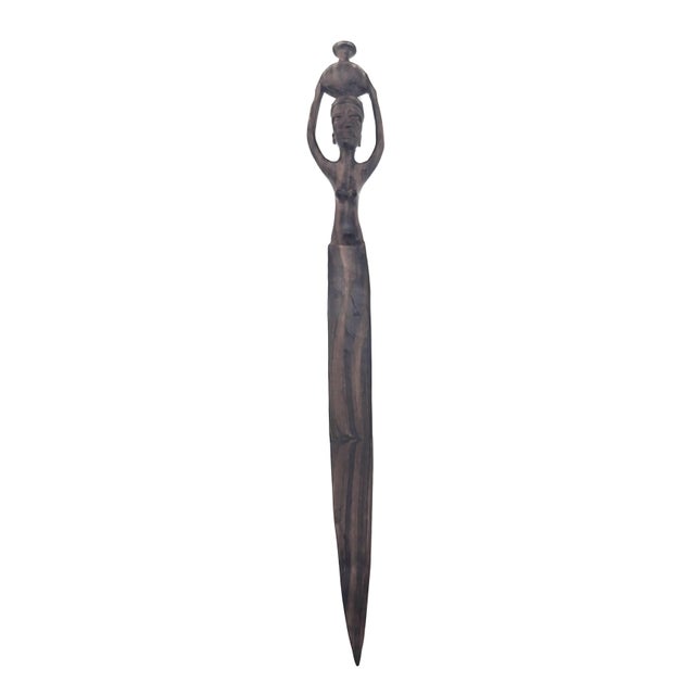 Offered is a handcrafted Iroko wood letter opener, depicting a woman bearing a water jug on her head. Iroko wood is from...