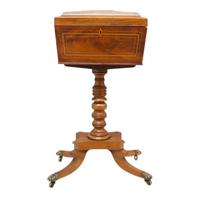 An 19th Century English Rosewood Tea Caddy, presented on a pedestal stand. This fine antique piece is crafted from...