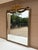 An elegant Italian giltwood mirror featuring carved floral swags, ribbon cresting, and a beautifully muted blue painted...