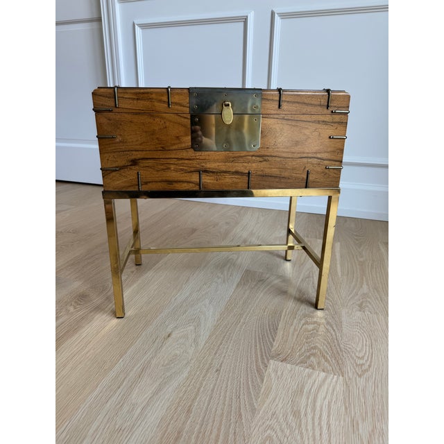Elegant, versatile, and exceptionally well-crafted, this vintage campaign-style storage chest is by Baker Furniture and...