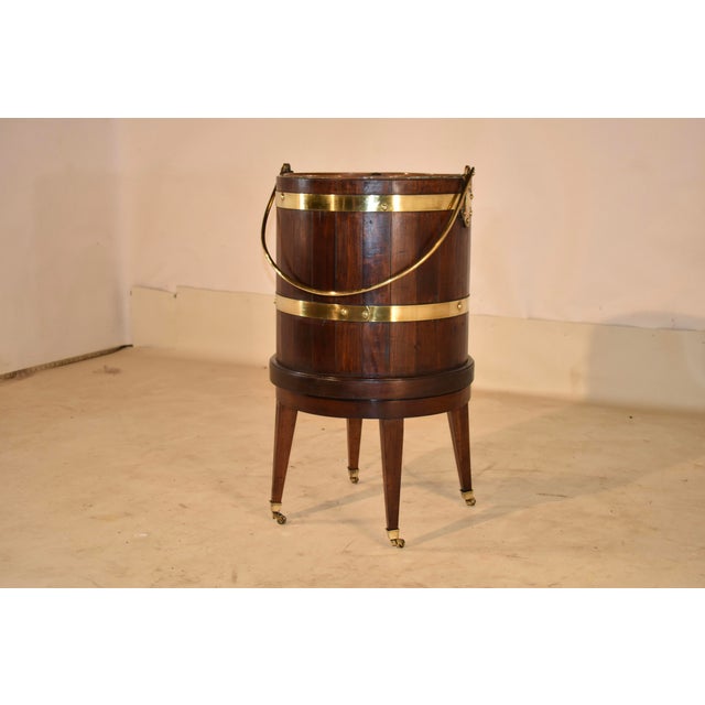 19th century mahogany planter or wine cooler from England strapped in brass. This piece is lovely! It is made from...