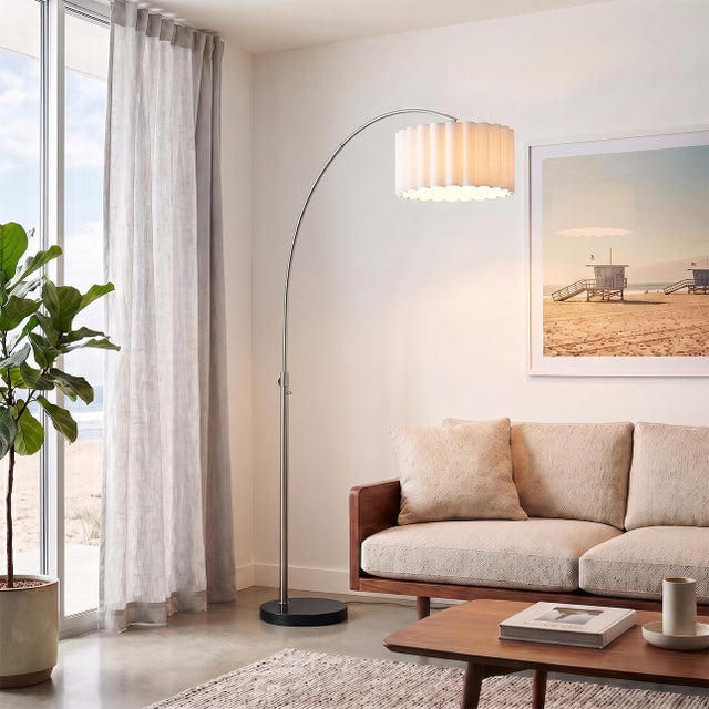 The Scallop Arc Lamp is a Modern arc lamp in NOVA's lighting line, featuring a satin nickel steel body paired with a black...