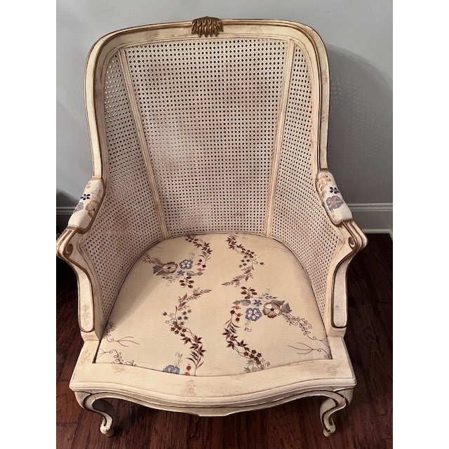 French Louis XVI style bergere arm chair featuring a classic cane back and a carved hardwood frame. Features: Graceful...