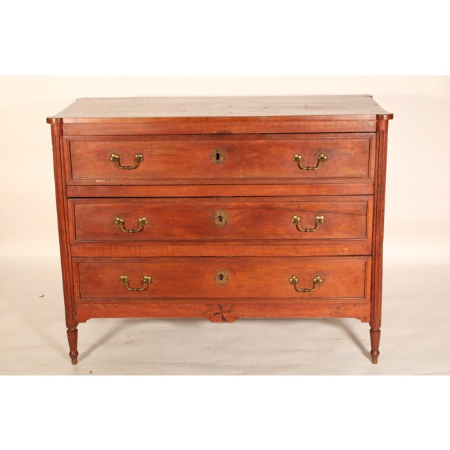 Antique Louis XVI style fruit wood chest of drawers, early 19th century. With a rectangular top with turret corners and...