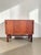 A truly beautiful piece: this Danish teak sideboard features two sliding doors and built-in storage. On one side, there is...