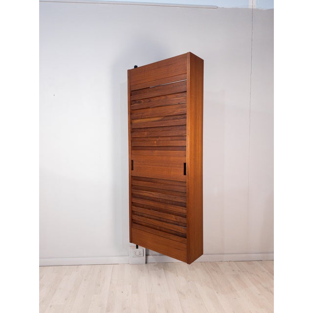 Italian suspended wardrobe and coat rack dating from the 1960s, characterized by a particularly rational design and an...