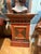 Add bold character and architectural charm to your space with this antique painted wood pedestal stand featuring a...