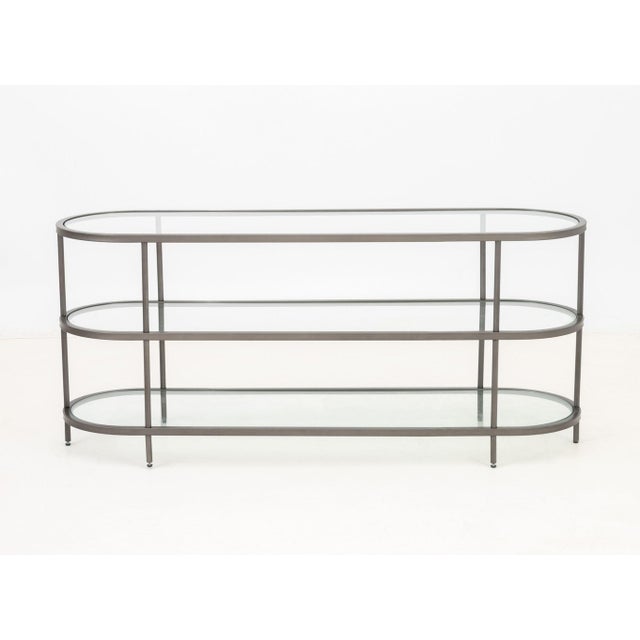 Modern Three Tier Glass Top Etagere Console, oval metal frame. 24.5" H x 55" W x 16" D. Provenance: From an East Village...