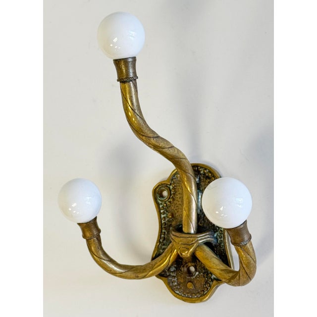Vintage French style embossed brass double wall hook with ceramic ball tips. Age wear. Patina to brass. Four holes for...