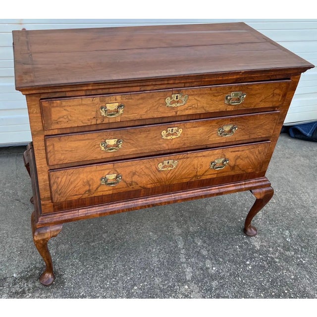 18th-century English Queen Anne crossbanded walnut chest on frame. Three herringbone-inlaid drawers with original 18th-...