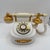 Vintage 1980s rotary dial telephone in white with ornate gold-tone Victorian-style detailing. Features a classic rotary...
