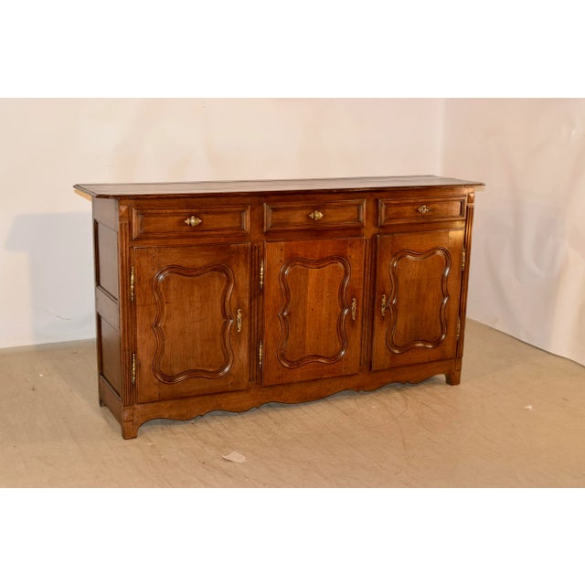 18th century oak enfilade from France with beveled edge around the top and a plate rail along the back. the sides are...