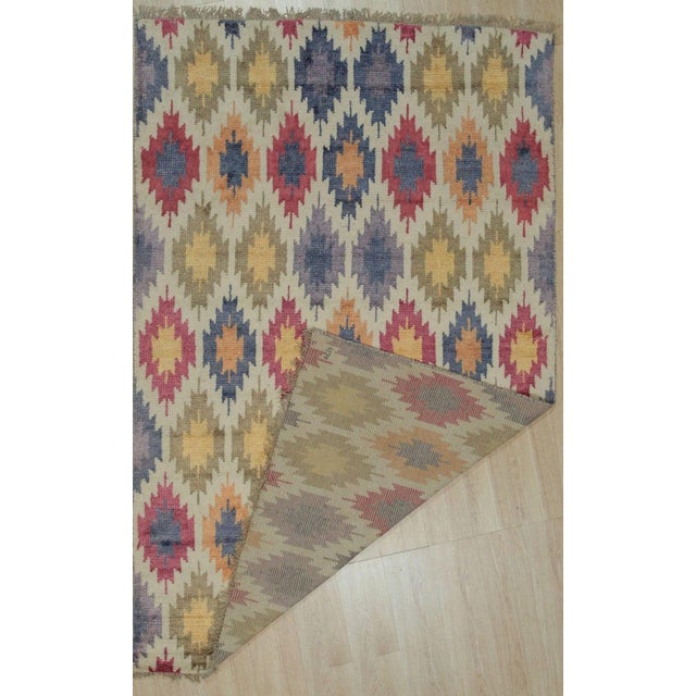 This hand knotted pile rug features a multicolor jewel tone palette and is crafted from a blend of durable wool and bamboo...