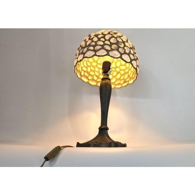 Unique table lamp made from cementyed seashells. The base is an art nouveau style metal base, which combines nicely. The...