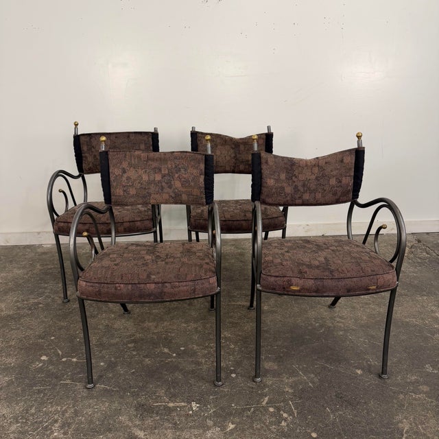 Set of 4 iron scrolled detailed dining chairs from Shaver Howard with brass detailing. These chairs have a grey finished...