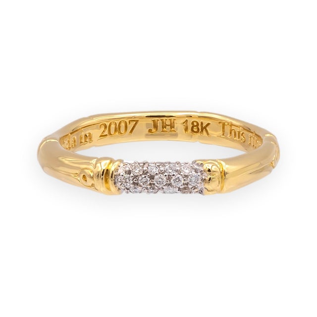 An 18k yellow gold band from John Hardy's Bamboo collection, with a single section of pavé-set round brilliant diamonds...