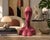 A striking modernist ceramic sculpture featuring an elongated abstract female bust rendered in a rich rose-red high-gloss...