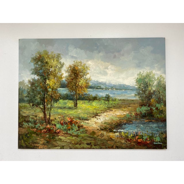Serene and light-filled impressionist landscape depicting a tranquil path winding toward a lake under a soft, cloud-filled...