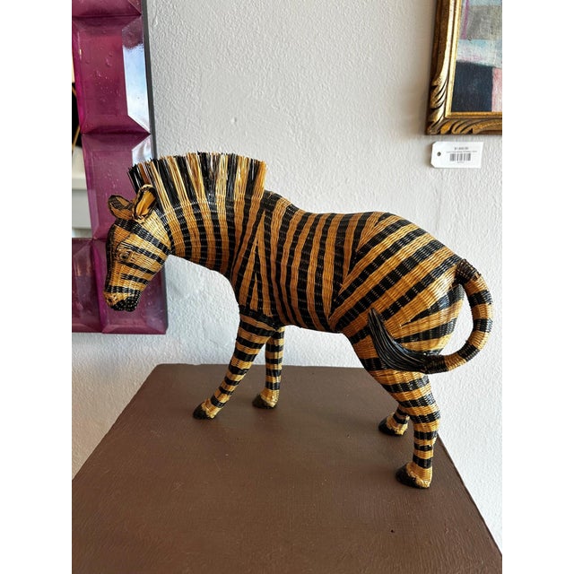 A beautifully crafted vintage woven zebra sculpture featuring hand-woven wicker construction with graphic black lacquer...