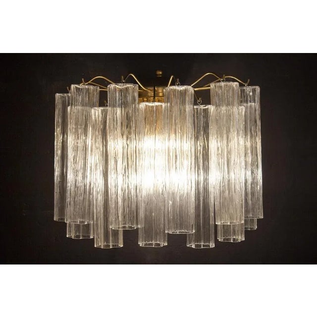 12 hand blown Murano glass Tronchi, each measuring 7.00” long. Five E14 light bulbs. This piece is attributed to the...