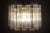 12 hand blown Murano glass Tronchi, each measuring 7.00” long. Five E14 light bulbs. This piece is attributed to the...