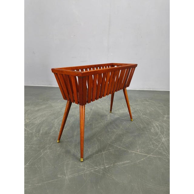 Mid-century modern teak planter made in Denmark in the 1960s. Crafted from solid teak wood, the planter features a refined...