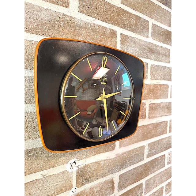 Original vintage wall clock produced by the historic french brand jaz, featuring a square case with rounded corners, a...