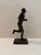 Dynamic vintage figurative sculpture depicting a long-distance runner in mid-stride, produced by Austin Productions in...