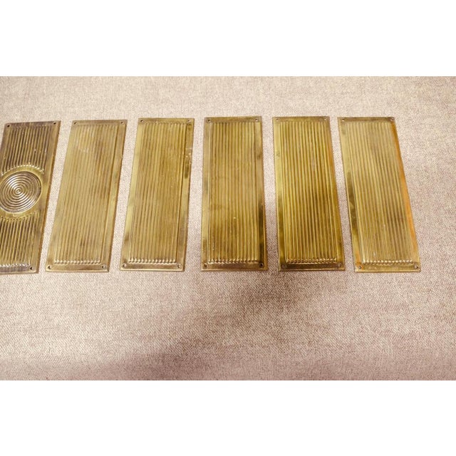 A Large Set of 12 Art Deco Brass Door Finger Plates There are 12 brass plates in the set, they are made in pressed brass...