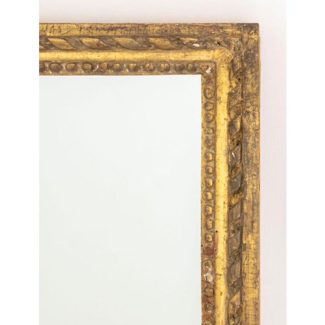 Neoclassical Style Giltwood Framed Mirror. Mirror plate: 17.25" H x 14" W; frame: 20.25" H x 17" W x 1" D. Provenance:...