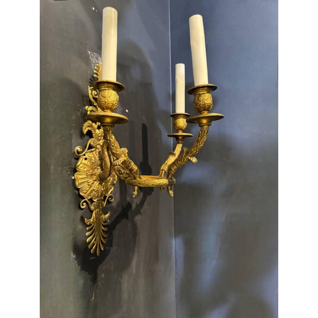 pair of circa 1920’s gilt bronze French Empire sconces with swan head holding a ring with 3 lights