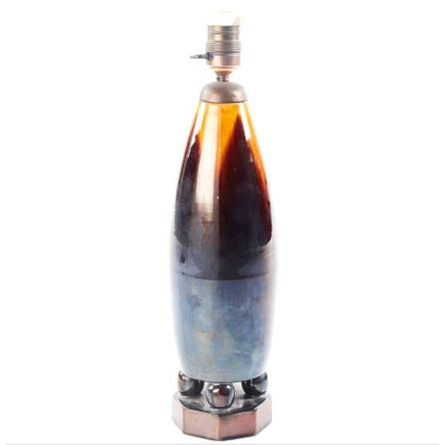 A glazed stoneware table lamp designed buy Michael Andersen, Bornholm, Denmark, circa 1920s-1930s. H- 17.3". Signed and...