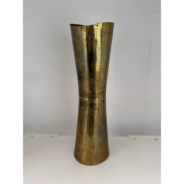 Italian artisan vase in hand-beaten brass 70s era The design of the vase narrows in the center and then widens at the ends