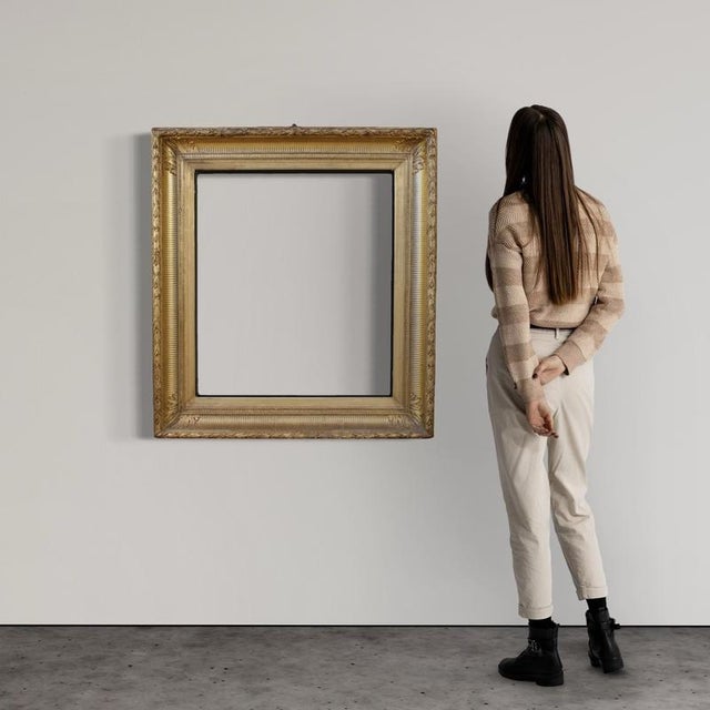 French frame from the first half of the 20th century. Louis XVI-style piece of furniture, made of wood and plaster, finely...