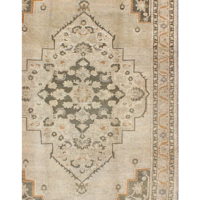 Vintage Turkish Oushak Rug with Floral Medallion Design in Light Tones, in neutrals, light orange and gray green. Keivan...