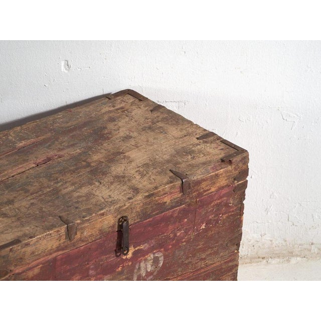 Antique Chinese painted trunk in pine wood, provincial furniture with red paint and inscription originating from northern...