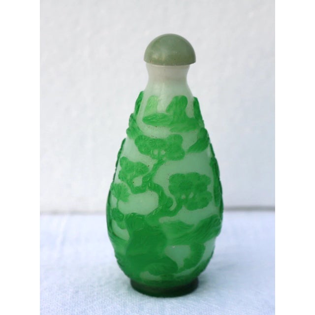 Elongated pear-shaped form, supported on a recessed round foot and rising to a cylindrical neck with a flat mouth. The...