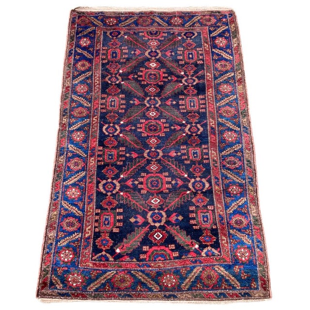 A lovely antique Kurdish rug, hand woven circa 1910 featuring an all over geometrical design of stylised flowers and vines...