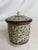 This lovely lidded jar features an intricate tapestry of flying herons with metallic details throughout, as well as the...
