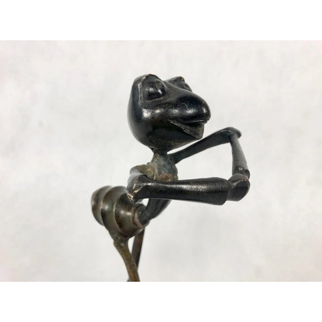 A modernist figurine of an ant, made of bronze, presented on a pedestal with a candlestick. An interesting item from the...