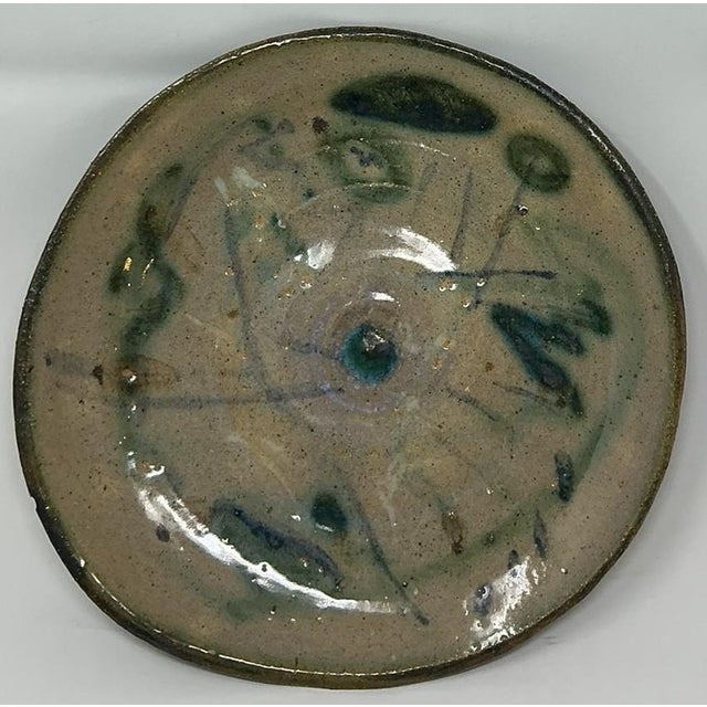 Toshiko Takaezu Shallow Bowl/Plate Abstract design with greens and blues against a neutral background. Brown-glazed bottom...
